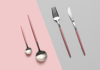 Stylish cutlery on color background