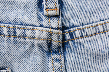 Stylish denim jeans as background, closeup