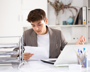 Businessman works in the office - puts documents in order and draws up a contract