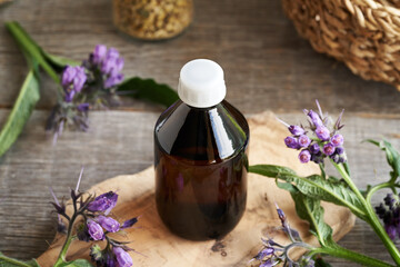A bottle of homemade comfrey tincture on a table