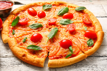 Tasty pizza margarita on white wooden background
