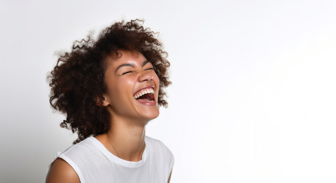 Portrait of a young african american woman laughing on white background