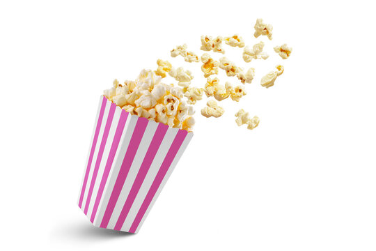 Popcorn flying out of pink white striped paper box isolated on white, transparent background, PNG, with copy space. Splash, levitation of popcorn grains.