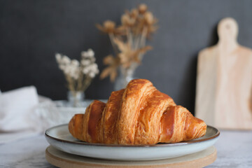 Home made croissant on the kitchen table top. pastry and bakery banner or breakfast concept.