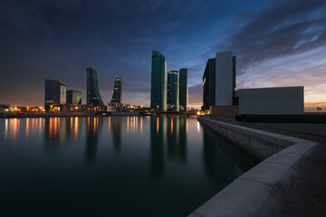 Beautiful sky with amazing colors and Bahrain skyline with reflection after dusk - Long Exposure