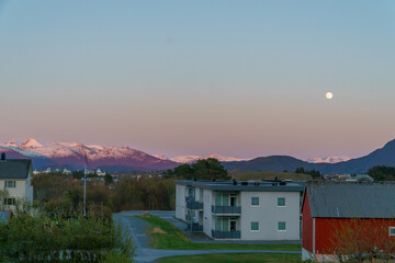 View of city and mountains sunset moon