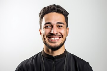 Obraz premium Portrait of a young latin man smiling on a white background