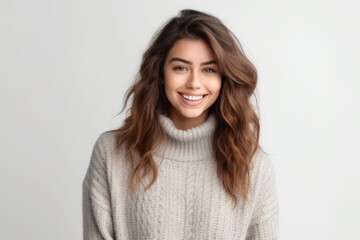 Obraz premium Portrait of a smiling young woman in sweater on white background.