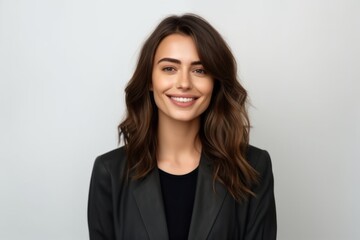 Obraz premium Medium shot portrait photography of a satisfied woman in her 30s that is wearing a sleek suit against a white background . Generative AI