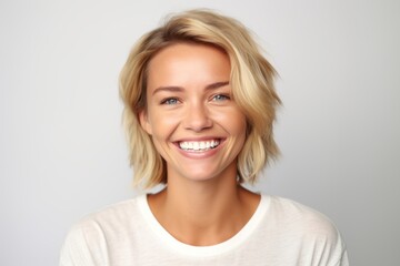 Medium shot portrait photography of a grinning woman in her 30s that is placed against a white background . Generative AI