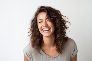 Fototapeta premium Portrait of a happy young woman laughing isolated on a white background