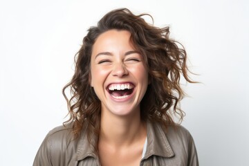 Obraz na płótnie Canvas Portrait of a happy young woman laughing isolated on a white background