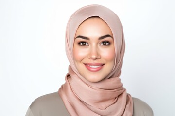 Portrait of beautiful Asian muslim woman wearing hijab smiling and looking at camera.