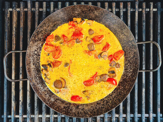 Cast iron skillet with scrambled eggs,mushrooms and tomatos top view / Cast iron frying pan / Cast iron pan