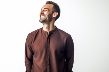 Cheerful young man laughing and looking up isolated on a white background