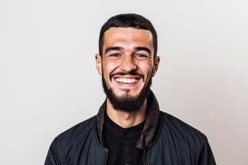 Obraz premium Portrait of a handsome young man smiling on a white background.