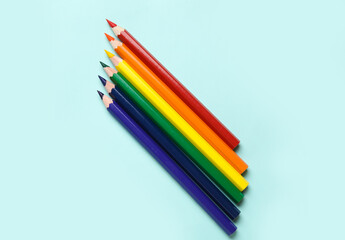 Colorful pencils on blue background. LGBT concept