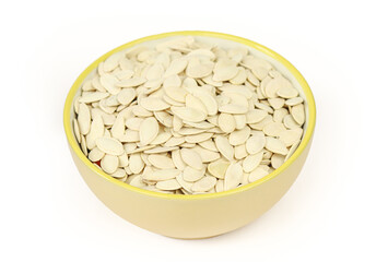 Bowl of pumpkin seeds snack isolated on white background