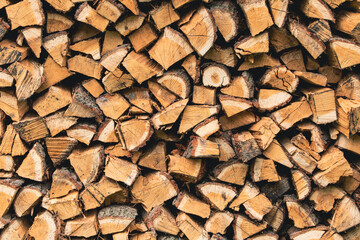 background of Heap firewood stack, natural wood / Firewood / textured firewood background of chopped wood for kindling and heating the house / a woodpile with stacked firewood