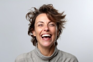 Close up portrait of a happy woman laughing and looking at the camera