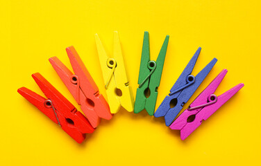 Colorful clothespins on yellow background. LGBT concept
