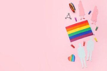 LGBT flag with paper human figures and symbols on pink background