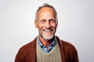 Fototapeta premium Portrait of a happy senior man smiling at camera isolated on a white background