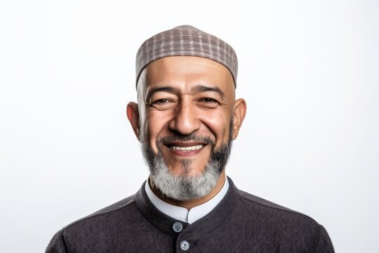 Portrait of a happy mature asian muslim man smiling isolated on white background