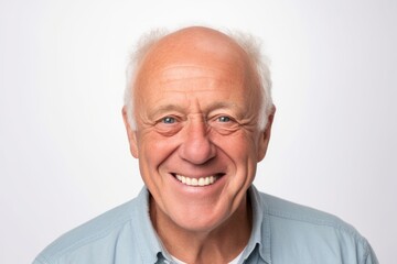 Fototapeta na wymiar Portrait of a happy senior man smiling at the camera on white background
