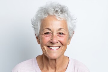 Fototapeta na wymiar Portrait of happy senior woman smiling at camera on white background.