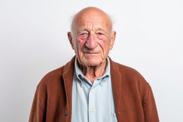 Obraz premium Portrait of happy senior man smiling and looking at camera against white background