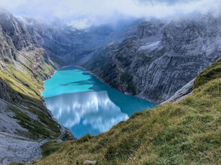 View of the Limmernsee dam in the canton of Glarus. Hiking high above the mountain lake in the Alps. Limmernsee Lake, Glarus, Switzerland