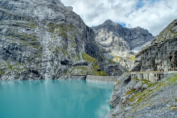 View of the Limmernsee dam in the canton of Glarus. Hiking high above the mountain lake in the Alps. Limmernsee Lake, Glarus, Switzerland