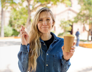 crossing fingers and hoping for good luck. take away coffee concept