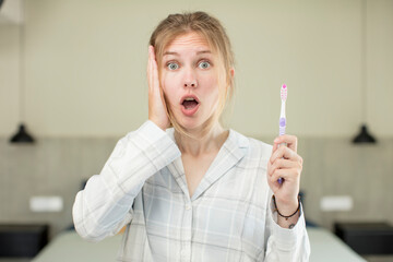 young pretty woman feeling extremely shocked and surprised. toothwash concept