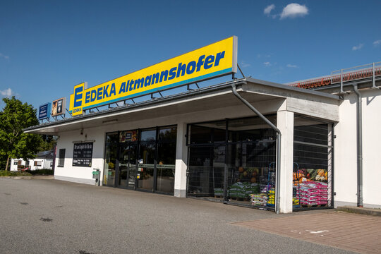 Tittling, Bavaria, Germany - May 29th 2023: Logo and Slogan (We love groceries) on a Edeka branch supermarket
