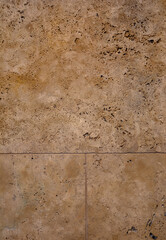 Tan and Brown Textured Marble Block Wall.