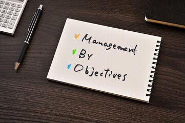 There is notebook with the word Management by Objectives. It is as an eye-catching image.
