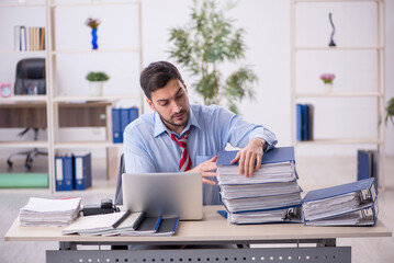 Fototapeta premium Young male employee working in the office