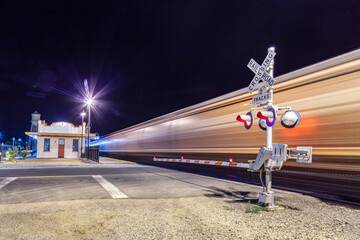 Railroad crossing by night with sign