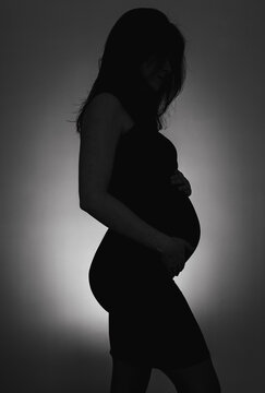 Silhouette of a pregnant woman in black and white on mother's day