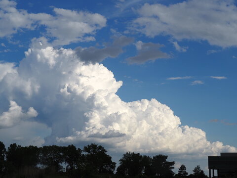Towering cumulus cloud in background with a "circle" cloud in the foreground. Photo taken 