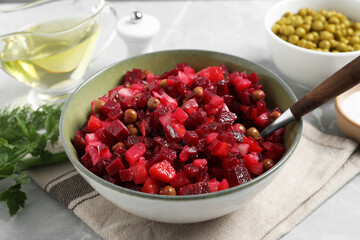 Bowl of delicious fresh vinaigrette salad on table, closeup
