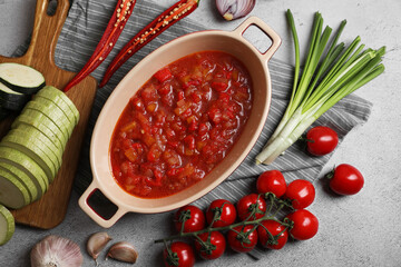 Dressing for ratatouille and different fresh vegetables on light grey table, flat lay