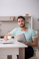 Young male freelancer working from home