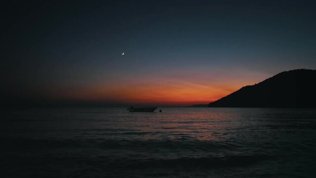 Moon Sea and Boat during twilight