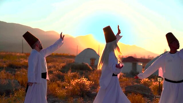 Dervish dance performed against the backdrop of nomads' yurts at sunset