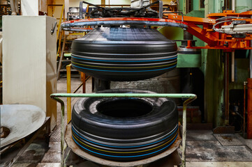 Huge raw tire before vulcanization process by press machine