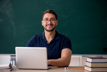 Young male teacher in telestudying concept