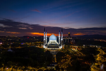 Aerial view of Masjid Sultan Salahuddin Abdul Aziz Shah - The Blue Mosque during sunset. Biggest Mosque in Southeast Asia, Shah Alam, Malaysia. 